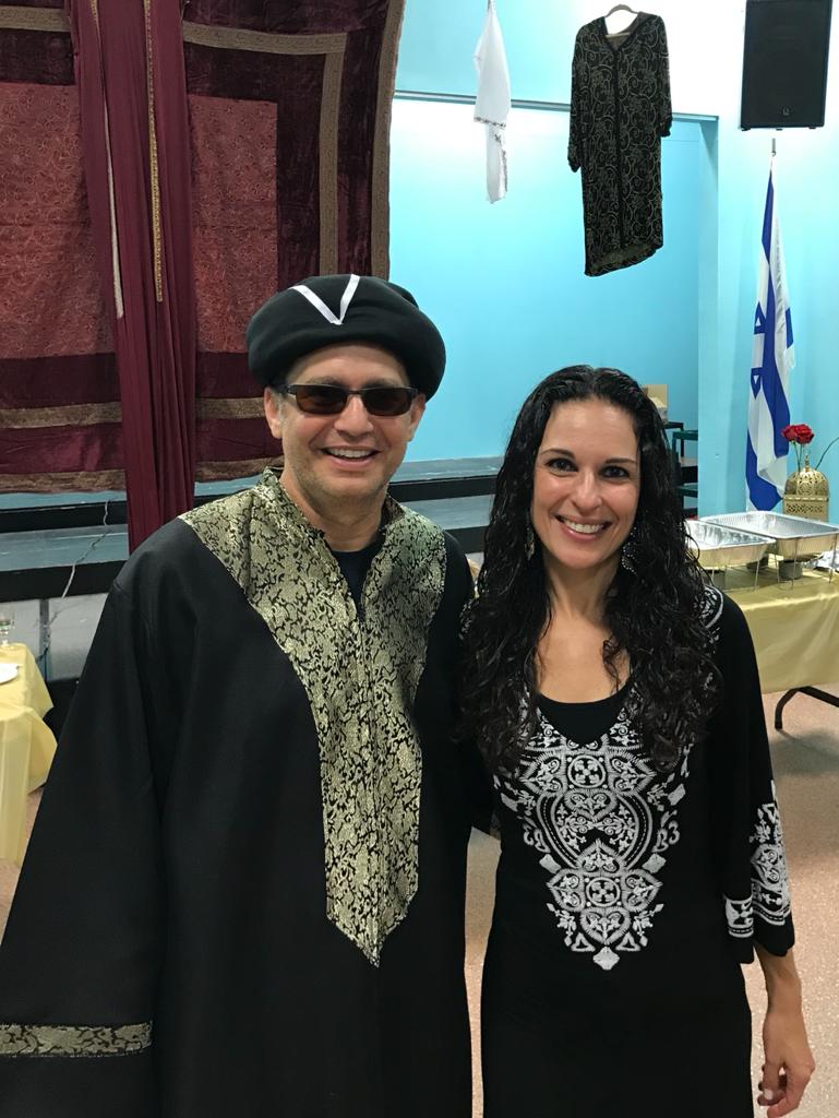 Community members in traditional Sephardic dress at a cultural celebration.